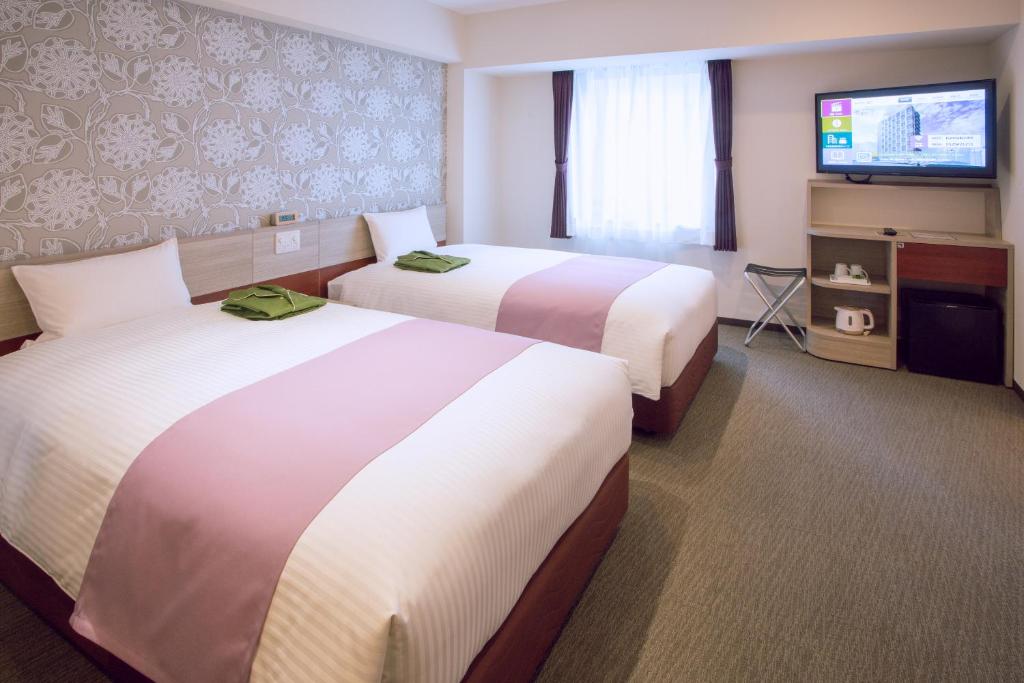 Postel nebo postele na pokoji v ubytování Kuretake Inn Premium Meieki minami