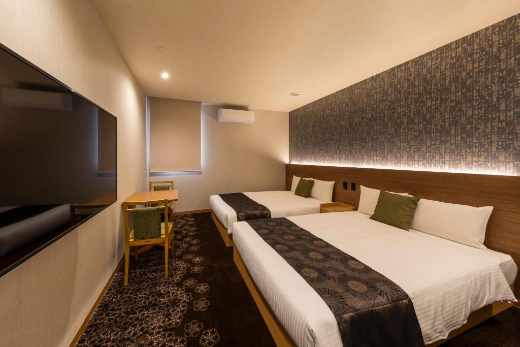 Postel nebo postele na pokoji v ubytování Chiyokura HOTEL SHUKU Nagoya