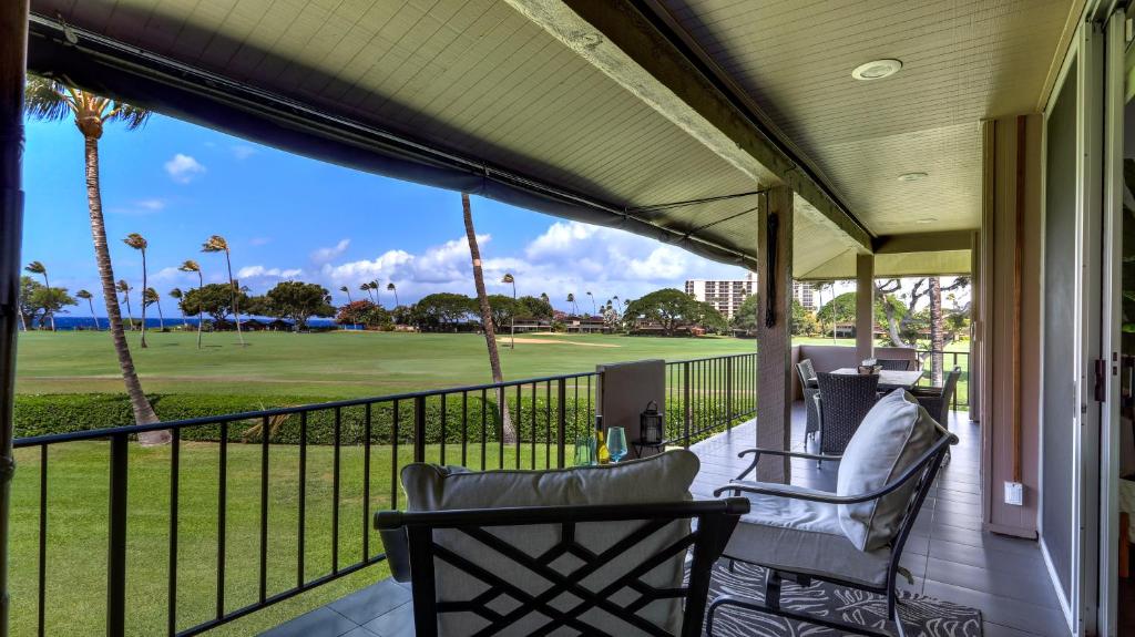 a porch with chairs and a view of a golf course at Maui Eldorado - J207 in Lahaina