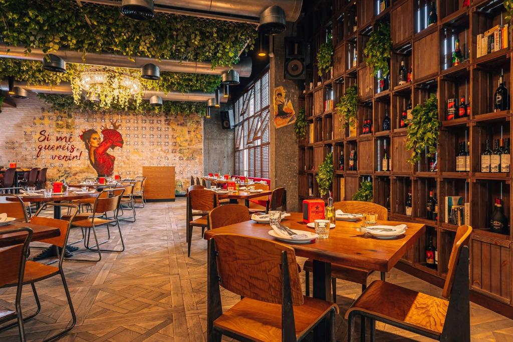 a restaurant with tables and chairs and a brick wall at TRYP by Wyndham Dubai in Dubai