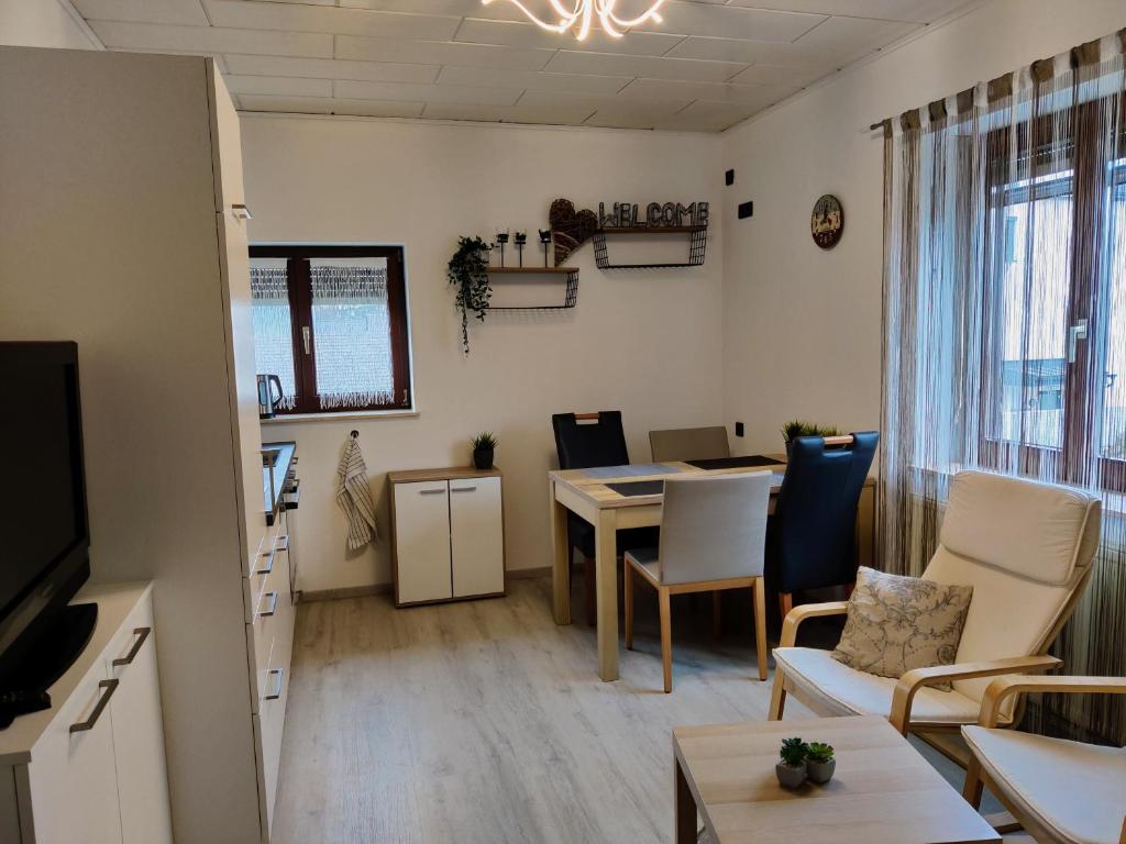 a living room with a table and a dining room at Holiday Home in Quiet Beautiful Area With Two Separate, Modern, Furnished Apartments in Deutsch-Wagram