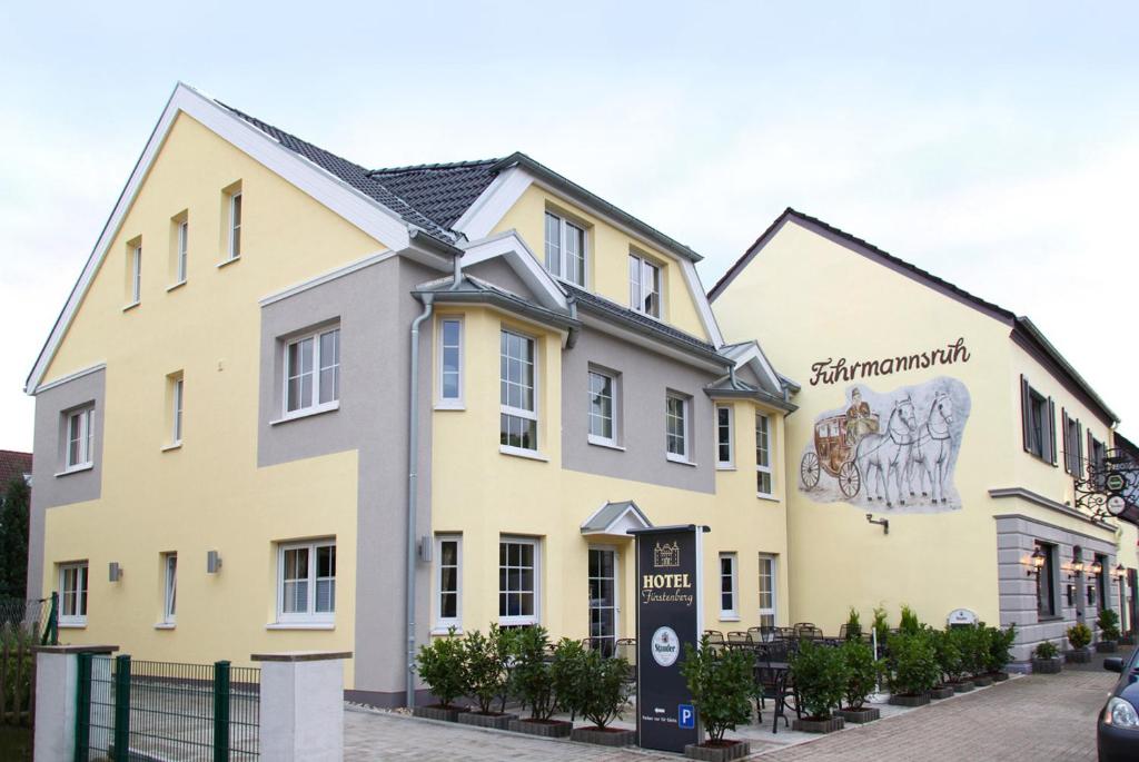 ein großes gelbes Gebäude mit einem Schild davor in der Unterkunft Hotel Fürstenberg in Essen