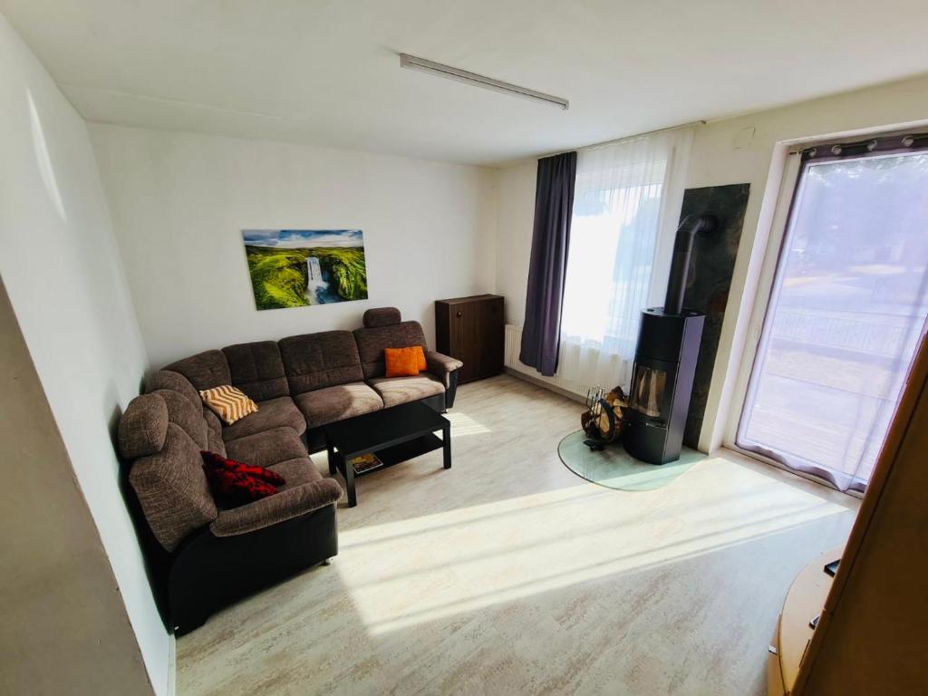 ein Wohnzimmer mit einem Sofa und einem TV in der Unterkunft Großartige 3 Zimmer Ferienwohnung mit Kamin und Garten für 1-6 Personen in Kaufbeuren