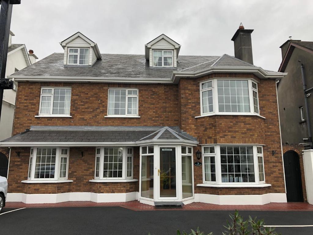 a red brick house with white windows and doors at Petra House B&B in Galway