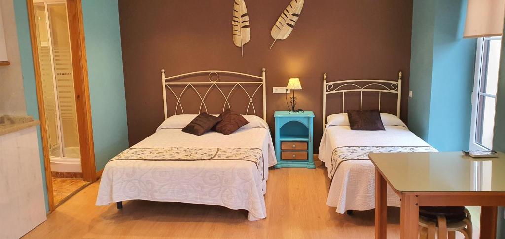 Łóżko lub łóżka w pokoju w obiekcie Hosteria Villa de Castro