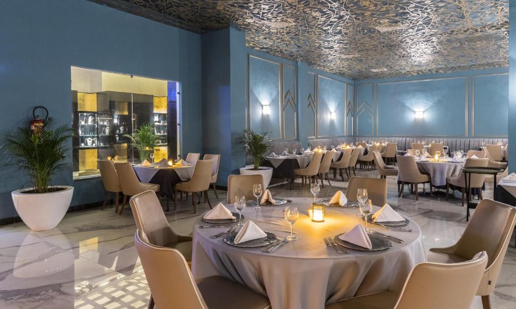 a dining room with tables and chairs and a ceiling at Savoy Le Grand Hotel Marrakech in Marrakesh