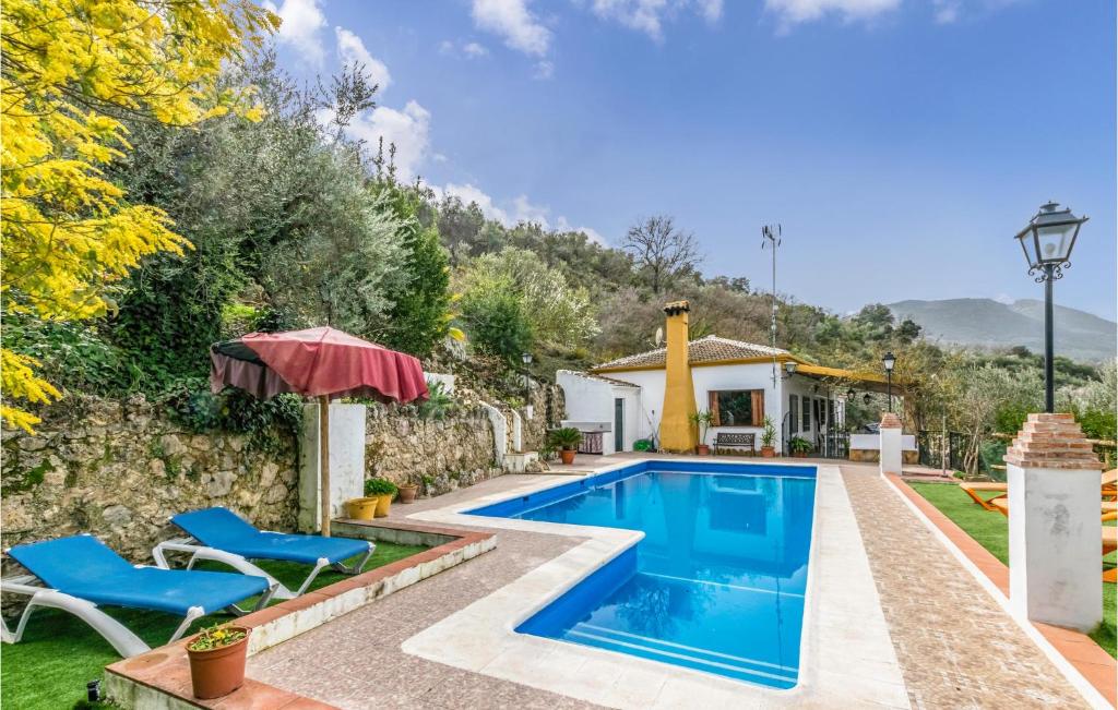 a villa with a swimming pool and a house at Stunning Home In Crdoba With Kitchen in Carcabuey