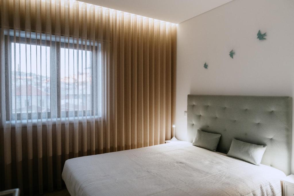 Cama ou camas em um quarto em Villa Teresa apartamentos