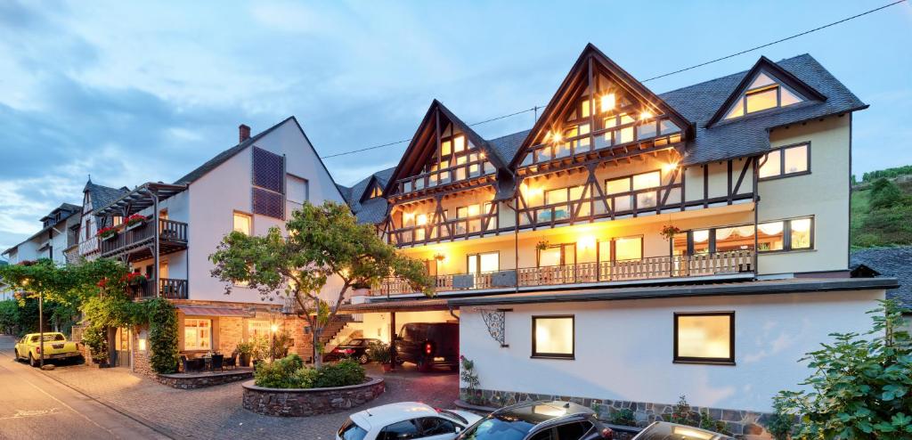 a large house with cars parked in front of it at Gästehaus Lenartz-Beth in Mesenich