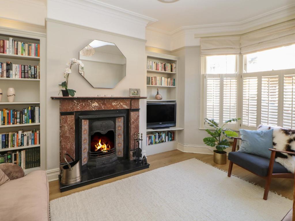 a living room with a fireplace and a tv at Number 15 in Thirsk