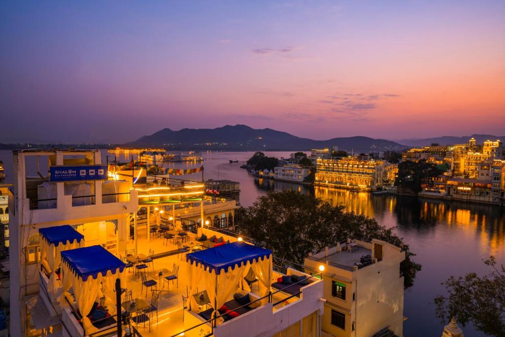 a view of a city at night at Shalom Backpackers Udaipur in Udaipur