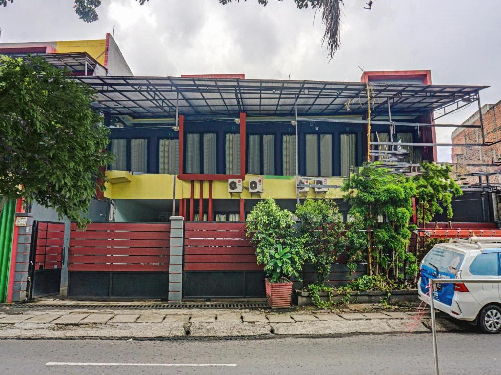 een gebouw met een rode bank ervoor bij Penginapan Marsya Prima Syariah in Jakarta
