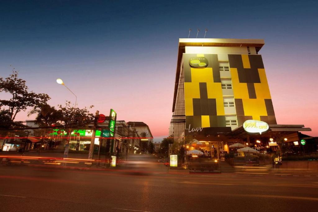 a tall building with a yellow and black building at Baiyoke Ciao Hotel in Chiang Mai