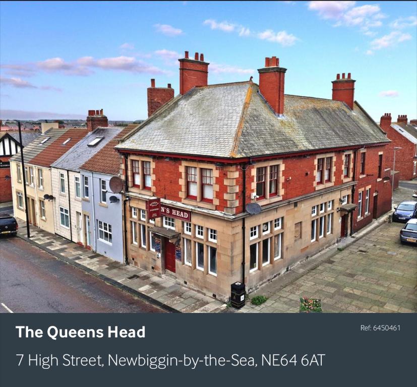 a group of buildings on a city street at The queens head in Newbiggin-by-the-Sea