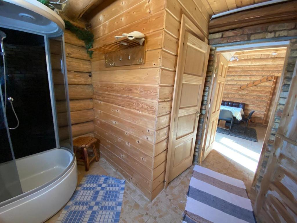 a bathroom with a tub and a toilet in a room at Avoti in Jūrkalne