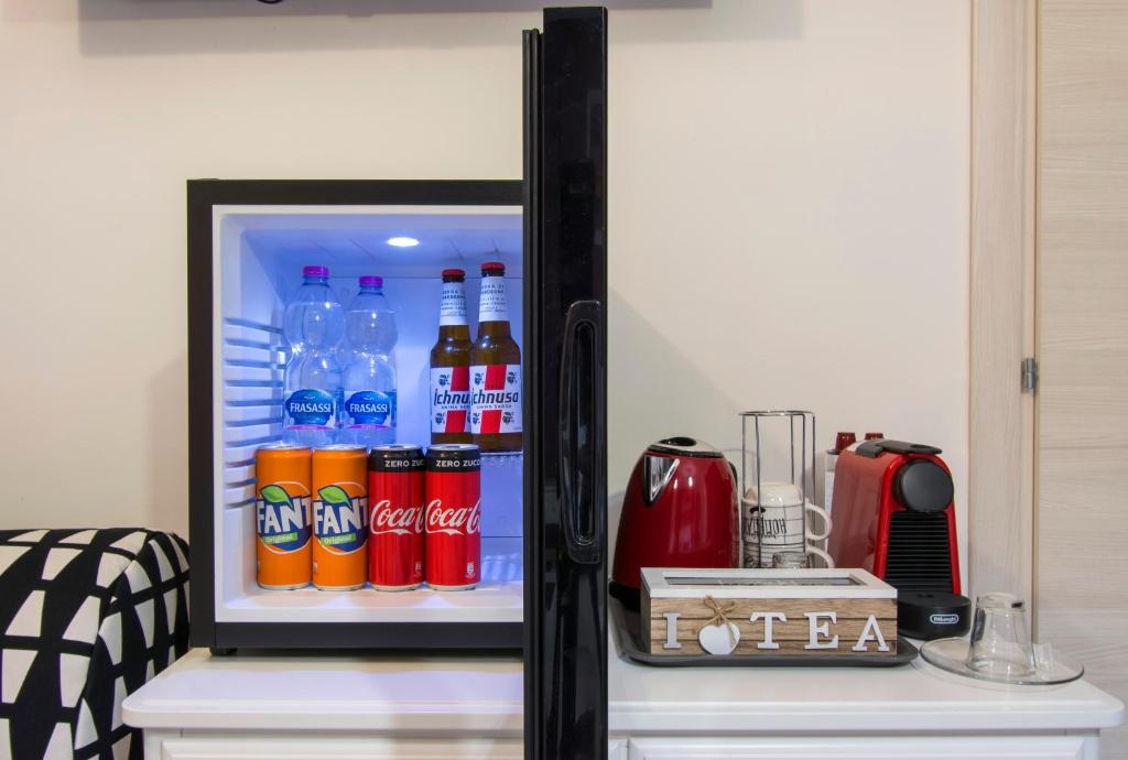 an open refrigerator filled with soda and drinks at Luxury Boutique Hotel in Rome