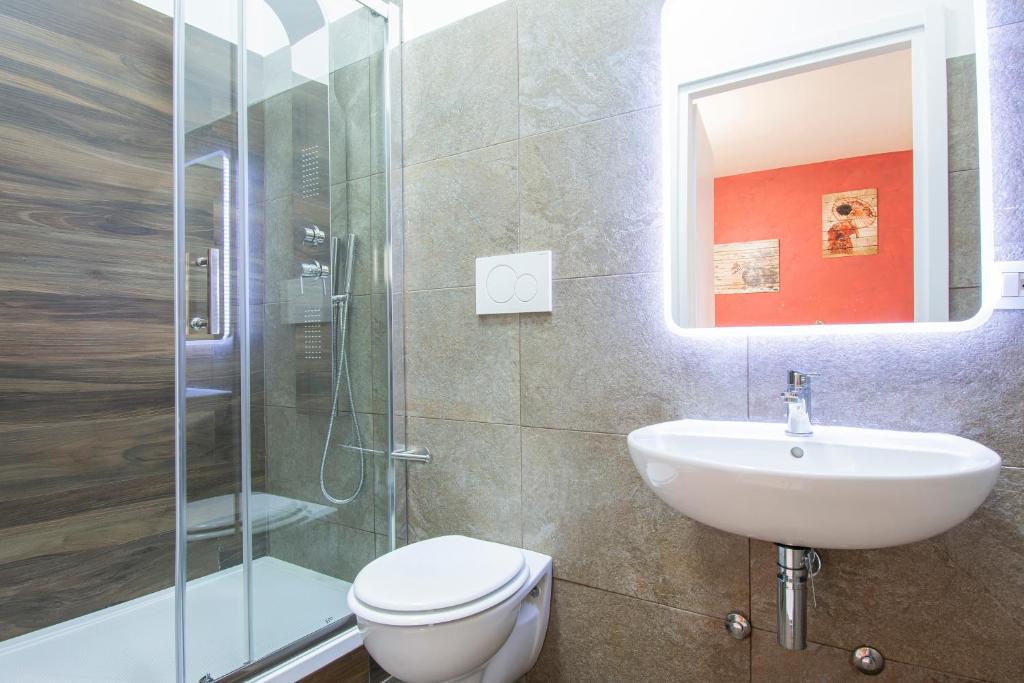 a bathroom with a toilet and a sink and a shower at Luxury Boutique Hotel in Rome