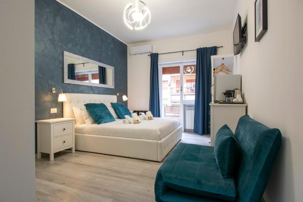 a bedroom with a bed and a couch and a chair at Luxury Boutique Hotel in Rome