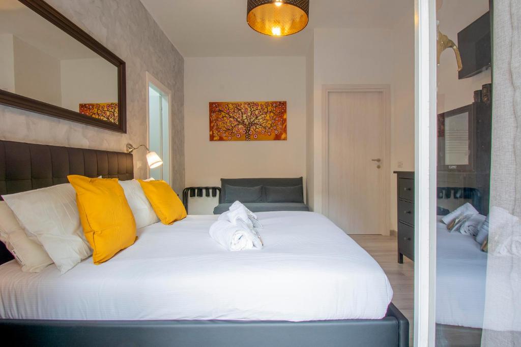 a bedroom with a bed with yellow and white pillows at Luxury Boutique Hotel in Rome