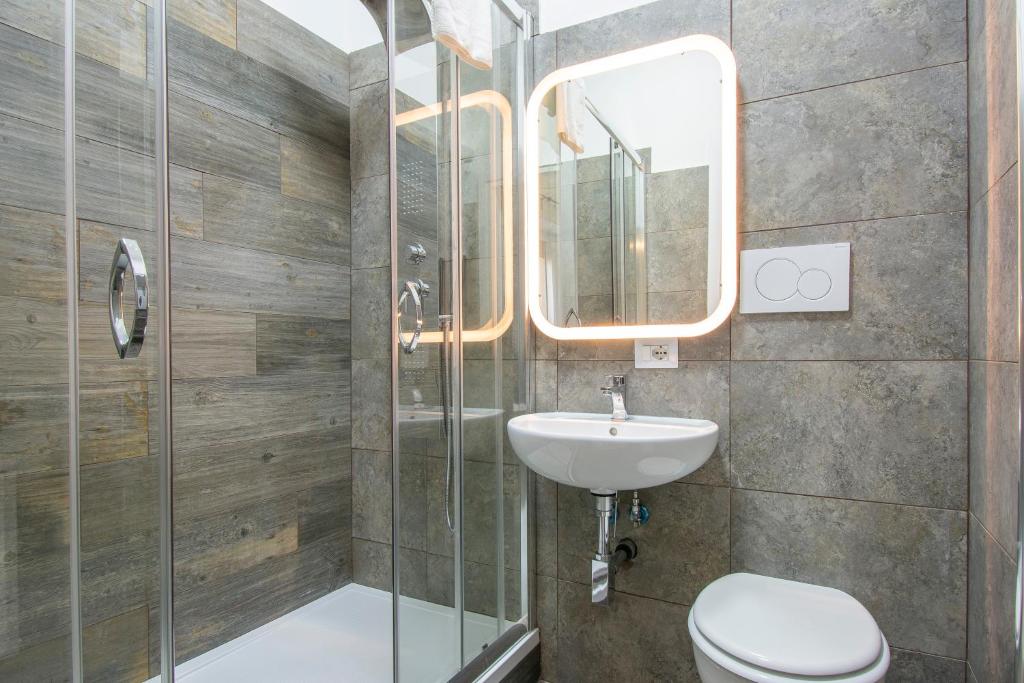 a bathroom with a toilet and a sink and a shower at Luxury Boutique Hotel in Rome