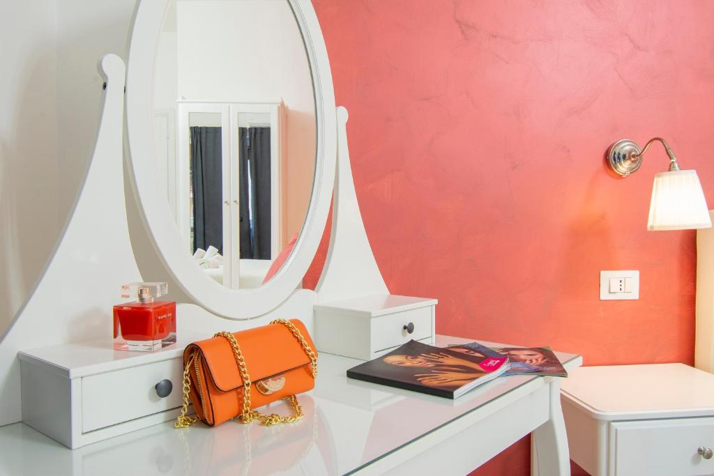 a dressing table with a mirror and a bag on it at Luxury Boutique Hotel in Rome