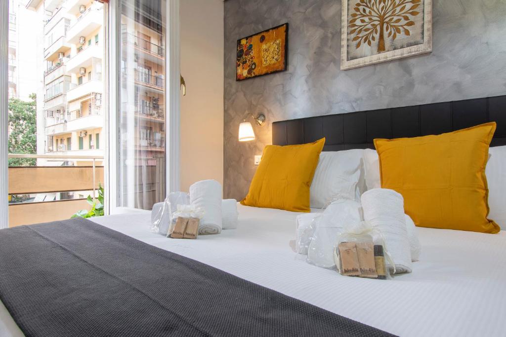 a bedroom with a bed with two boxes on it at Luxury Boutique Hotel in Rome