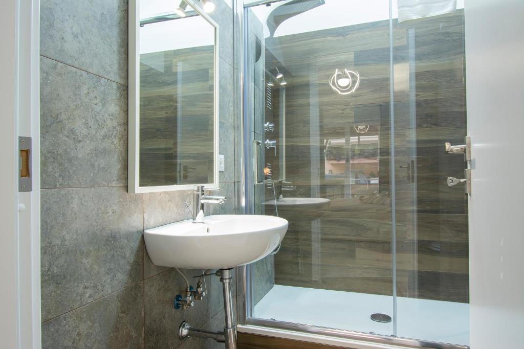 a bathroom with a sink and a shower at Luxury Boutique Hotel in Rome