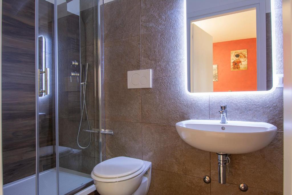 a bathroom with a toilet and a sink and a shower at Luxury Boutique Hotel in Rome