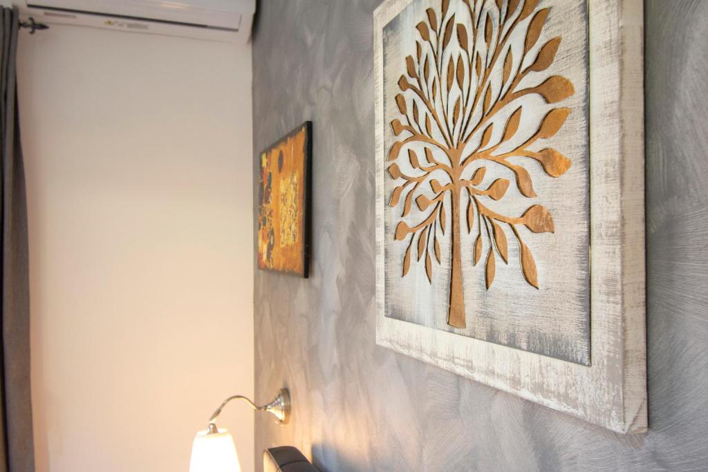 a room with a lamp and a painting on a wall at Luxury Boutique Hotel in Rome