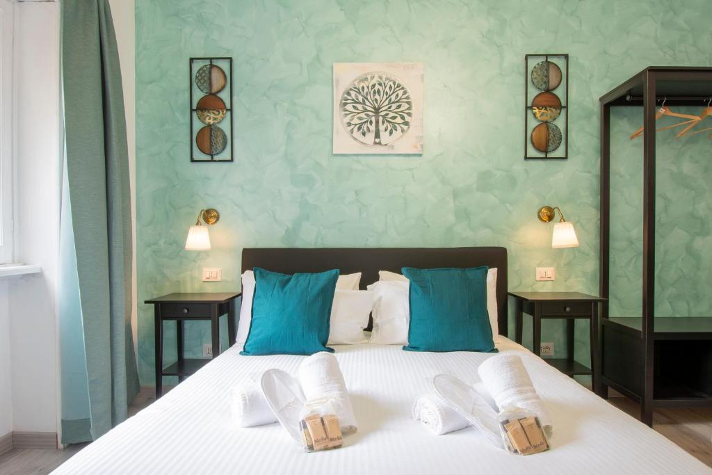 a bedroom with a bed with blue and white pillows at Luxury Boutique Hotel in Rome