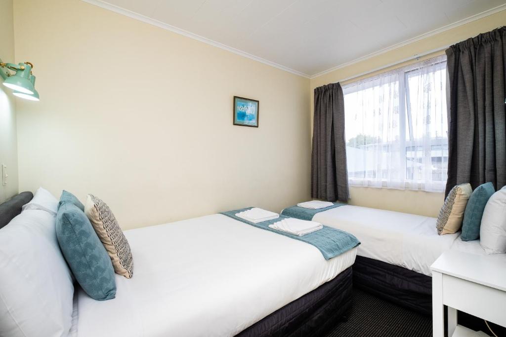 Postel nebo postele na pokoji v ubytování Chevron Motel