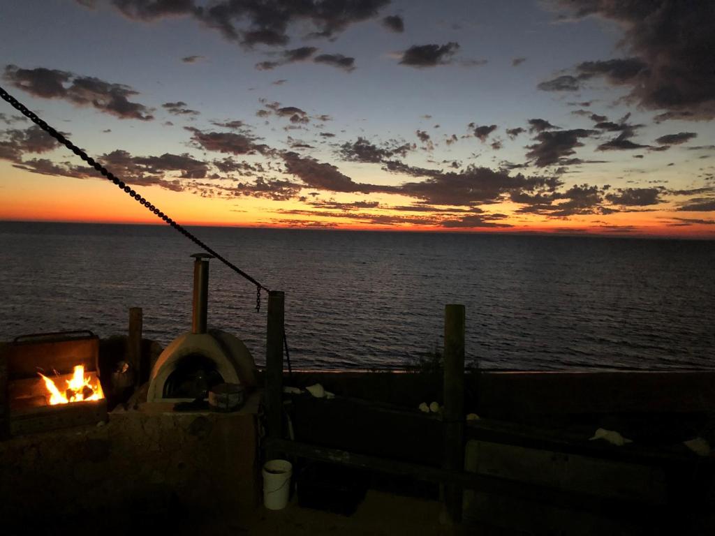 a fire pit on a cruise ship at sunset at Wilderness Island in Exmouth