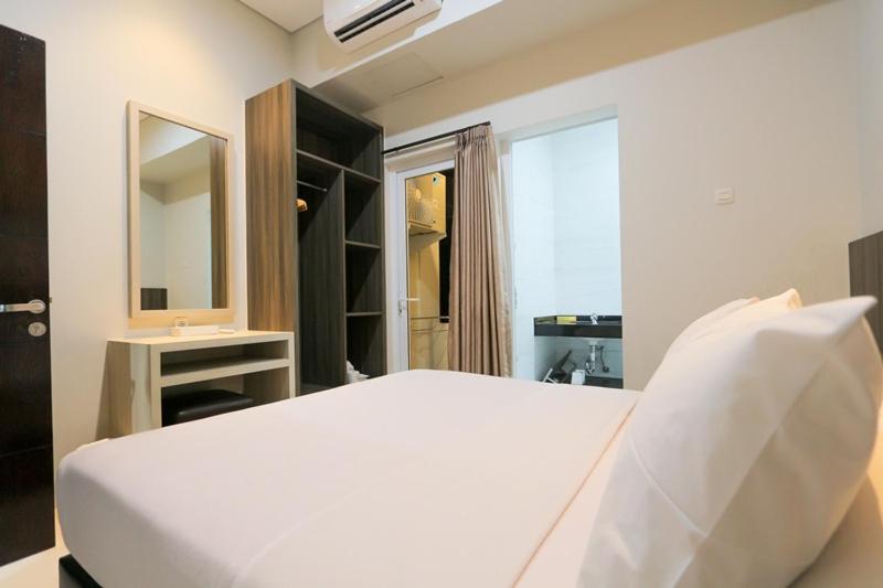Llit o llits en una habitació de Sun In Pangandaran Hotel