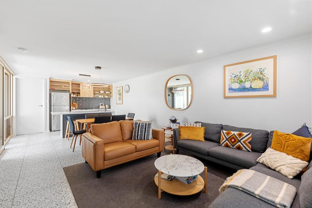 a living room with a couch and chairs and a table at City Courtyard Two Apartment in Mount Gambier