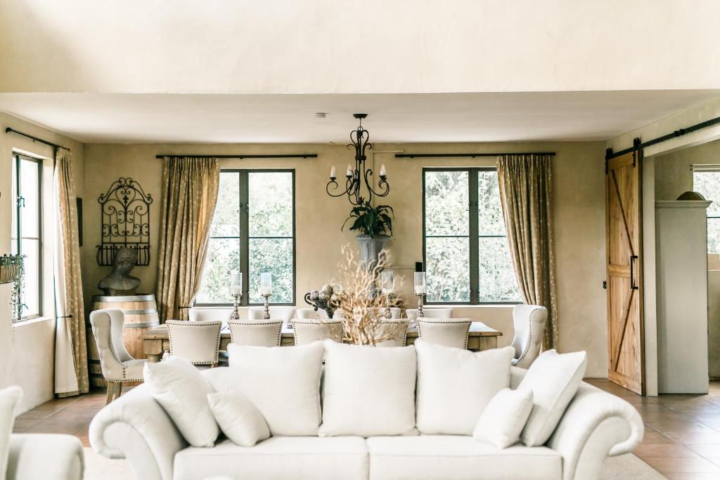 a living room with a white couch and a table at Villa Vie in Tauranga