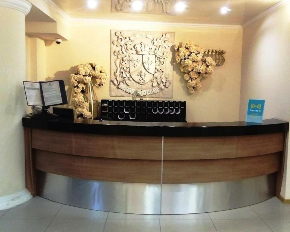 a reception desk with a keyboard and flowers on the wall at Prince Vladimir in Vladimir