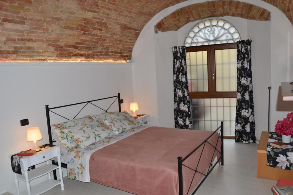 Postel nebo postele na pokoji v ubytování Assisi, Angolo di Matilde