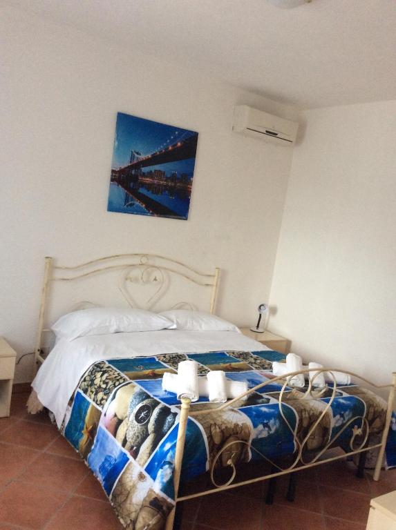 a bedroom with a bed with a painting on the wall at Residence rosa blu in Castellabate