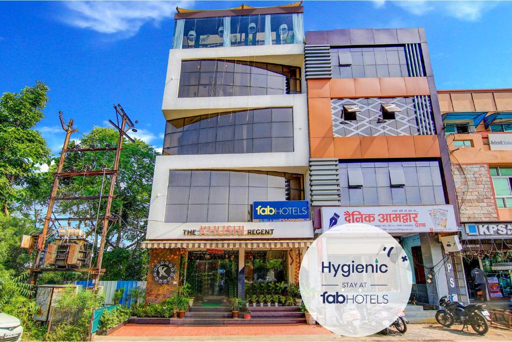 a tall building with a sign in front of it at FabHotel The Khushi Regent in Bhopal