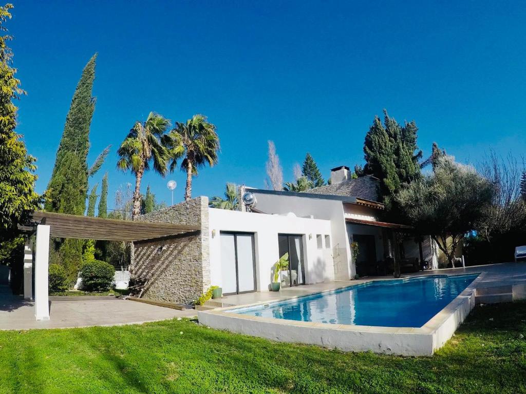 a house with a swimming pool in the yard at The Stone Villa in Pissouri