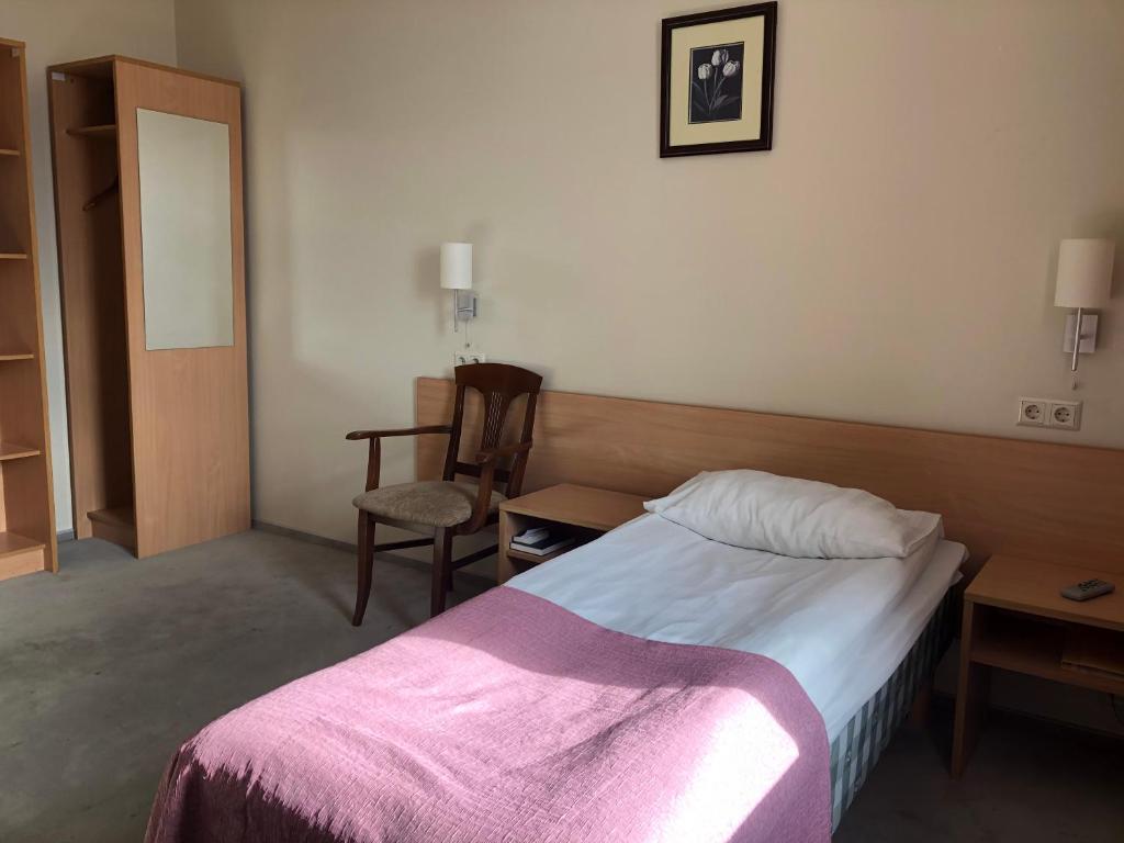 Postel nebo postele na pokoji v ubytování TOSS Hotel