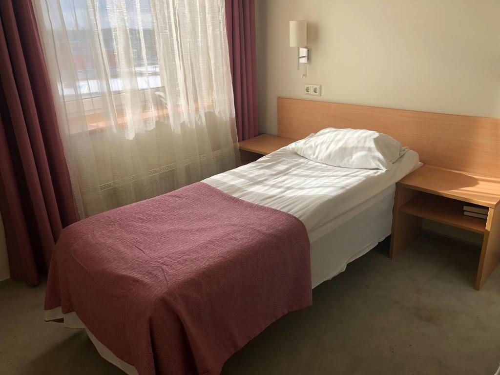 Postel nebo postele na pokoji v ubytování TOSS Hotel