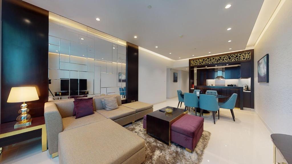 a living room with a couch and a table at Hometown Apartments - Modern Sophisticated 3BR Apartmet in Upper Crest Downtown in Dubai