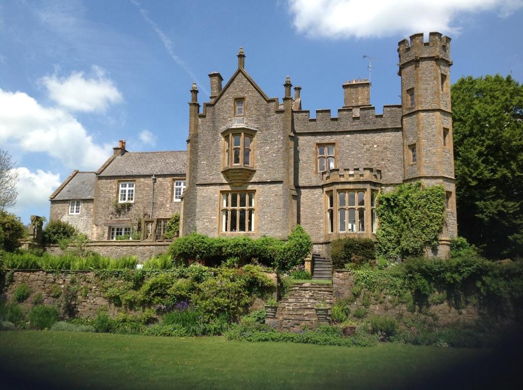 an old castle with a staircase in front of it at Greenham Hall in Wellington