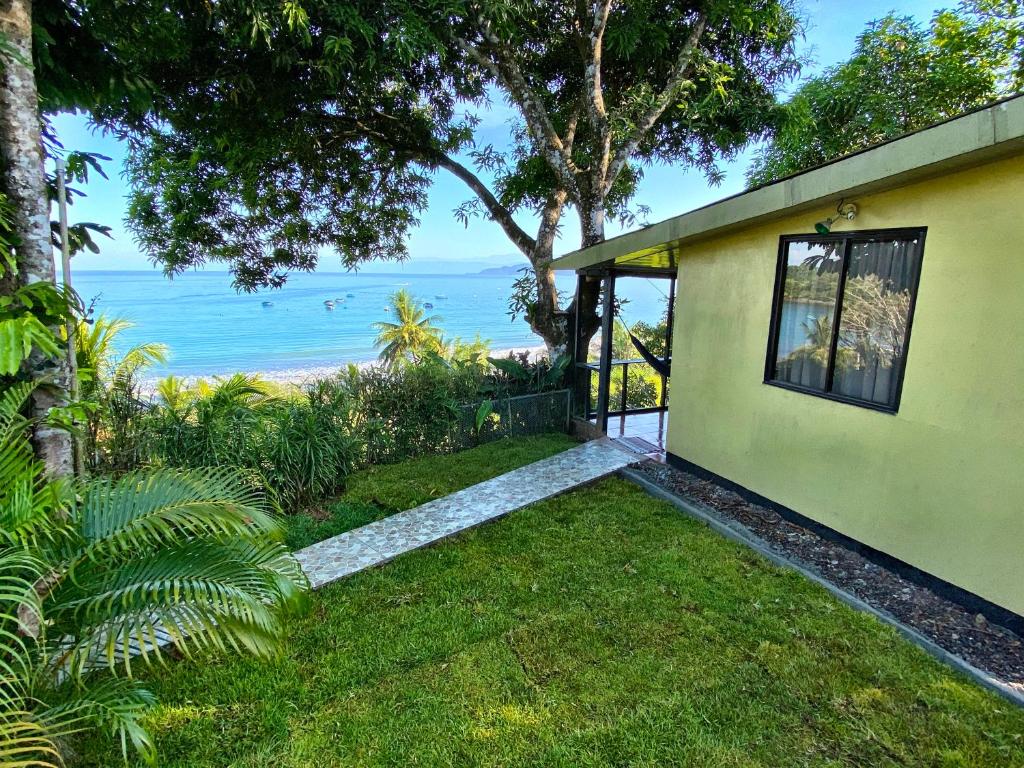 a house with a view of the ocean at Pacheco Tours Beach Cabins in Drake
