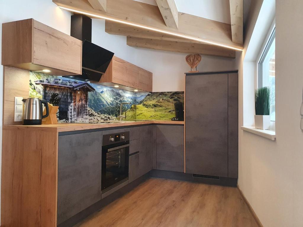 A kitchen or kitchenette at Alpen Appartements Viehhofen near Saalbach & Zell am See - incl Sommercard