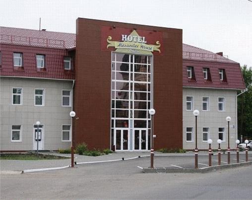 a hotel building with a large glass door at Alexander House in Barnaul
