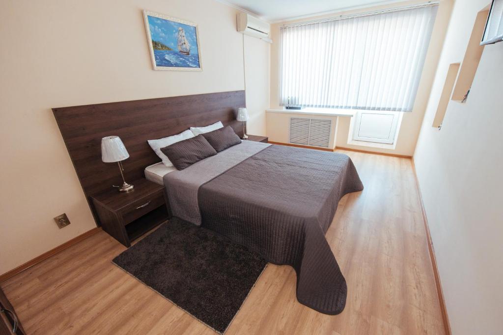 Un dormitorio con una cama grande y una ventana en Yuzhnyy Bereg Hotel, en Yeysk