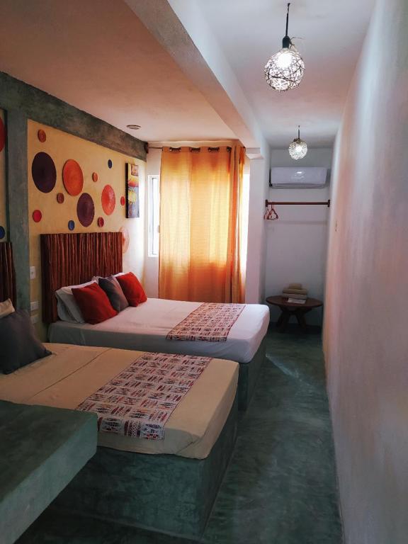 Postel nebo postele na pokoji v ubytování Hotel Jardin Mahahual