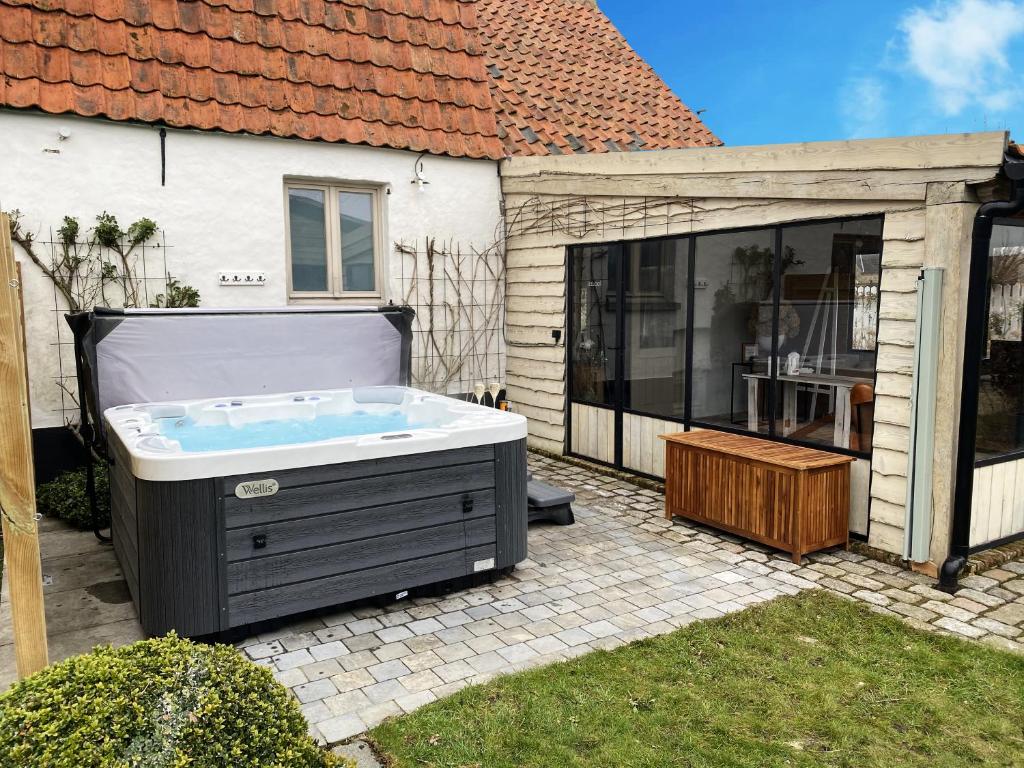 a hot tub in the backyard of a house at d'Oude Smidse in Zuienkerke